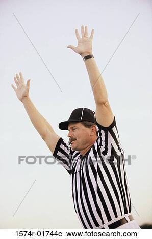 Referee raising his hands blowing a whistle View Large Photo Image Stock Image - Referee raising his hands blowing a whistle. Fotosearch