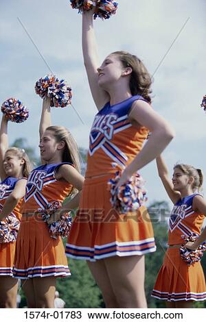 Side profile of cheerleaders with pom-poms View Large Photo Image Stock Image - Side profile of cheerleaders with pom-poms. Fotosearch