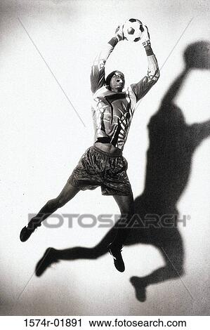 Stock Image - Soccer goalie saving a ball. Fotosearch