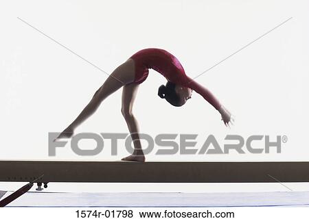 Stock Photo - Teenage girl on a balance beam. Fotosearch