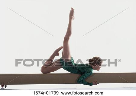Teenage girl on a balance beam View Large Photo Image Stock Photo - Teenage girl on a balance beam. Fotosearch
