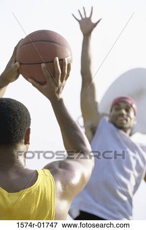Two men playing basketball View Large Photo Image Stock Photo - Two men playing basketball. Fotosearch