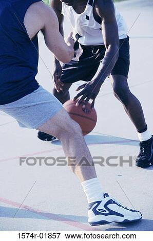 Two men playing basketball View Large Photo Image Stock Photo - Two men playing basketball. Fotosearch