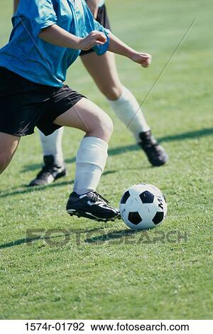 Two teenagers playing soccer View Large Photo Image Stock Image - Two teenagers playing soccer. Fotosearch