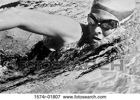 Woman swimming in a swimming pool View Large Photo Image Stock Photo - Woman swimming in a swimming pool. Fotosearch