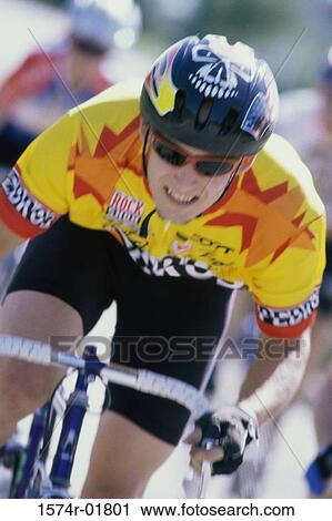 Young man cycling in a race View Large Photo Image Stock Image - Young man cycling in a race. Fotosearch
