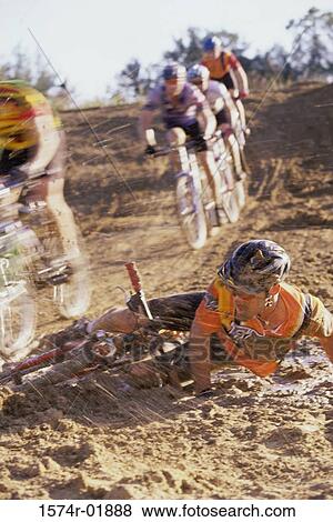 Young man falling from a bicycle in a race View Large Photo Image Stock Photo - Young man falling from a bicycle in a race. Fotosearch