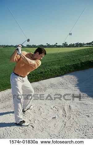 Stock Image - Young man playing golf. Fotosearch
