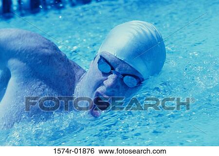 Stock Photograph - Young man swimming in a pool. Fotosearch