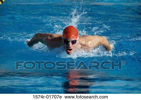 Stock Image - Young man swimming the butterfly stroke. Fotosearch