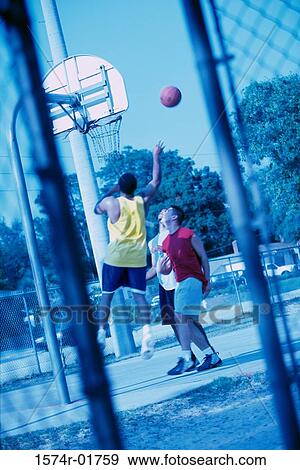 Young men playing basketball View Large Photo Image Stock Photo - Young men playing basketball. Fotosearch