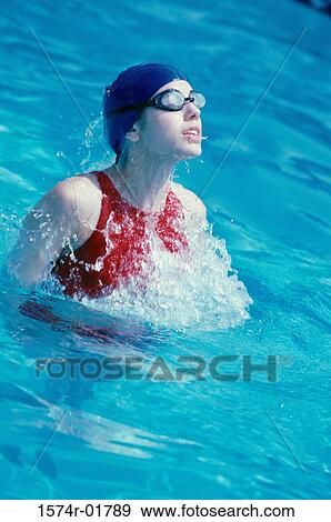 Young woman in a swimming pool View Large Photo Image Stock Photo - Young woman in a swimming pool. Fotosearch
