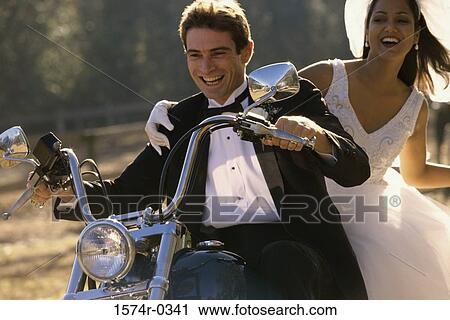 Bride and bridegroom on a motorcycle View Large Photo Image Stock Image - Bride and bridegroom on a motorcycle. Fotosearch
