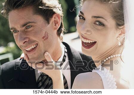 Stock Image - Close-up of a bride and bridegroom smiling. Fotosearch