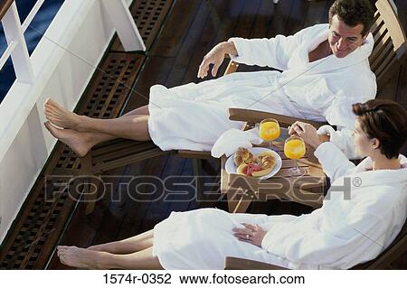 High angle view of a couple sitting on lounge chairs on a yacht View Large Photo Image Stock Image - High angle view of a couple sitting on lounge chairs on a yacht. Fotosearch