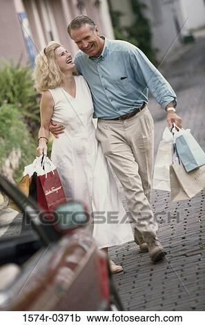 Stock Image - Mid adult couple shopping. Fotosearch
