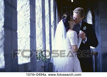 Newlywed couple kissing each other View Large Photo Image Stock Image - Newlywed couple kissing each other. Fotosearch