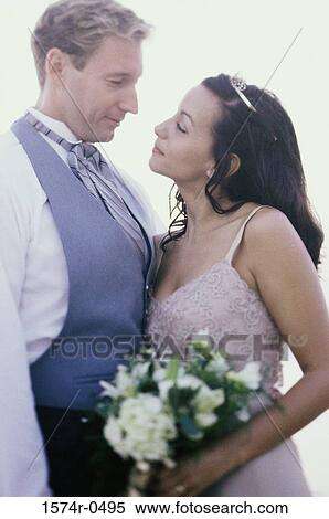 Stock Photography - Newlywed couple looking at each other. Fotosearch