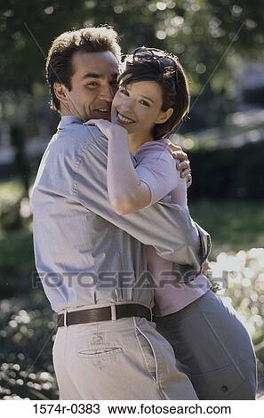 Stock Image - Portrait of a young couple holding each other. Fotosearch