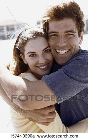 Stock Image - Portrait of a young couple smiling. Fotosearch