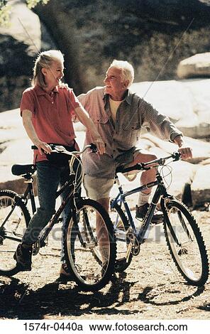 Senior couple holding bicycles at the beach View Large Photo Image Stock Image - Senior couple holding bicycles at the beach. Fotosearch