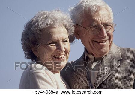 Stock Image - Senior couple standing together smiling. Fotosearch