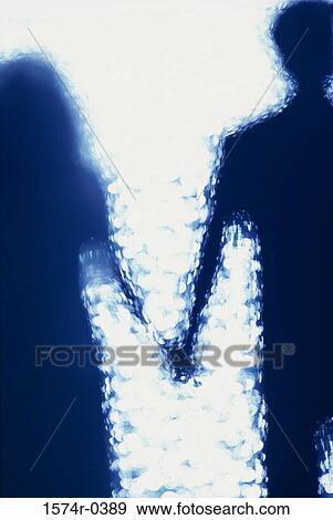 Stock Photo - Silhouette of a couple holding hands. Fotosearch