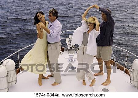 Stock Image - Two couples dancing on a boat. Fotosearch