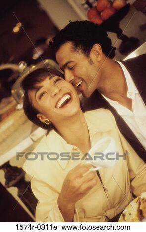 Stock Image - Young couple cuddling. Fotosearch