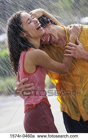 Young couple holding each other in the rain View Large Photo Image Stock Image - Young couple holding each other in the rain. Fotosearch