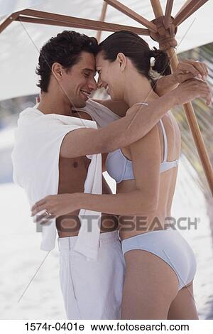 Young couple holding each other View Large Photo Image Stock Image - Young couple holding each other. Fotosearch