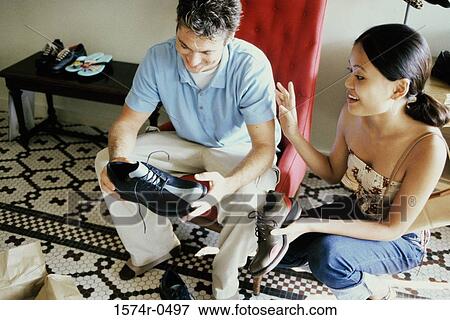 Stock Photo - Young couple in a shoe store. Fotosearch