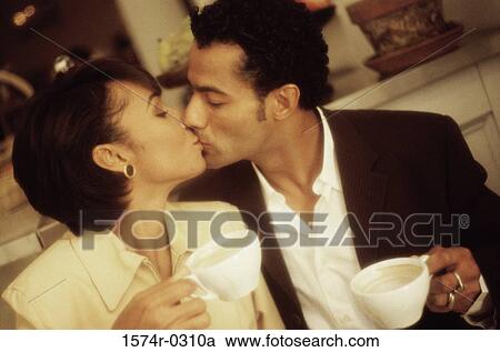 Stock Image - Young couple kissing each other. Fotosearch