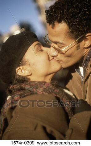 Stock Photo - Young couple kissing with their eyes closed. Fotosearch