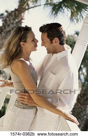 Stock Image - Young couple looking at each other. Fotosearch