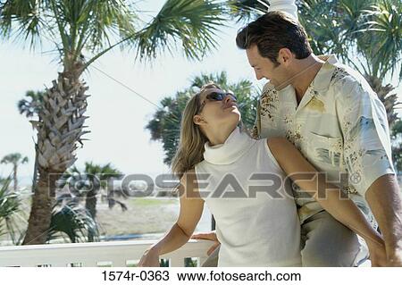 Young couple looking at each other View Large Photo Image Stock Image - Young couple looking at each other. Fotosearch