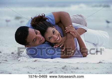 Young couple playing on the beach View Large Photo Image Stock Photo - Young couple playing on the beach. Fotosearch