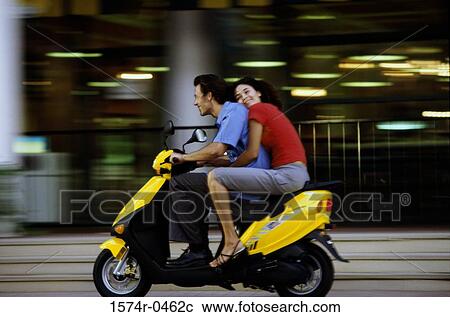 Young couple riding on a motor scooter View Large Photo Image Stock Image - Young couple riding on a motor scooter. Fotosearch