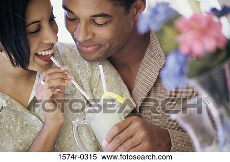 Young couple sharing a drink View Large Photo Image Stock Photography - Young couple sharing a drink. Fotosearch