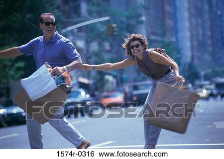 Young couple with shopping bags View Large Photo Image Stock Photograph - Young couple with shopping bags. Fotosearch
