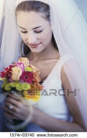 Bride holding a bouquet of flowers View Large Photo Image Stock Image - Bride holding a bouquet of flowers. Fotosearch