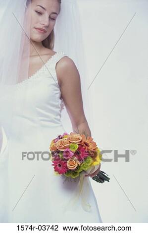 Stock Image - Bride holding a bouquet of flowers. Fotosearch