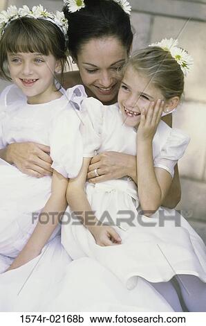 Bride hugging two flower girls View Large Photo Image Stock Image - Bride hugging two flower girls. Fotosearch