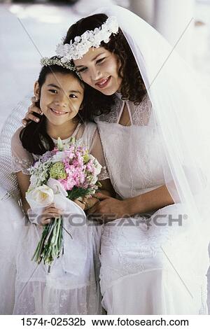 Bride smiling with a flower girl View Large Photo Image Stock Image - Bride smiling with a flower girl. Fotosearch