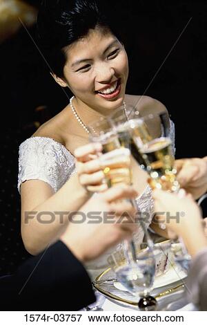 Bride toasting with glasses of champagne View Large Photo Image Stock Photo - Bride toasting with glasses of champagne. Fotosearch