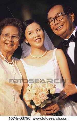 Close-up of a bride smiling with her parents View Large Photo Image Stock Image - Close-up of a bride smiling with her parents. Fotosearch