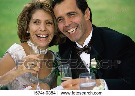 Close-up of a newlywed couple drinking champagne View Large Photo Image Stock Image - Close-up of a newlywed couple drinking champagne. Fotosearch