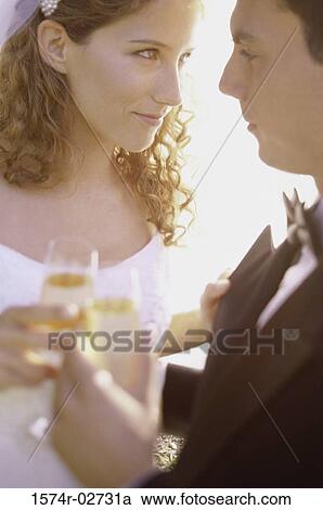 Close-up of a newlywed couple looking at each other View Large Photo Image Stock Image - Close-up of a newlywed couple looking at each other. Fotosearch
