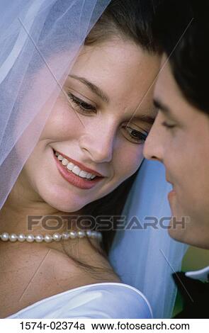 Close-up of a newlywed couple smiling View Large Photo Image Stock Image - Close-up of a newlywed couple smiling. Fotosearch