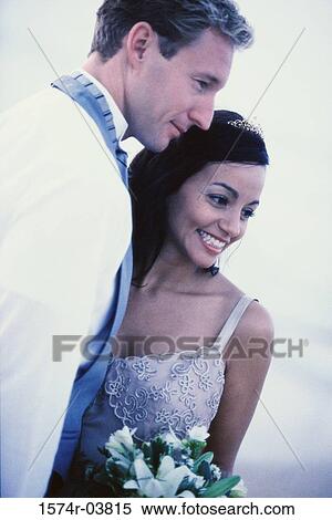 Close-up of a newlywed couple smiling View Large Photo Image Stock Photography - Close-up of a newlywed couple smiling. Fotosearch
